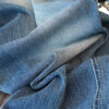 Washed Blue Curved Wide-Leg Denim Pants — Vintage Fade & Relaxed Knife-Leg Shape